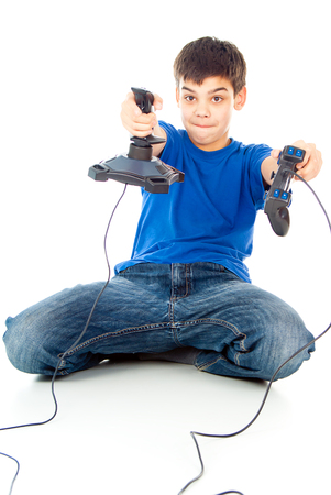 boy with two joysticks plays video gamesの写真素材