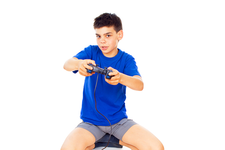 handsome boy plays with a joystick isolatedの写真素材
