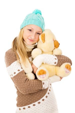 girl in a cap and a toy bearの写真素材