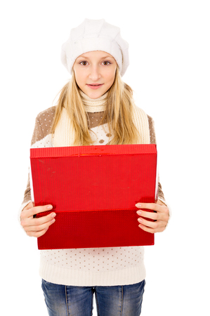 teenage girl in a winter cap with a giftの写真素材