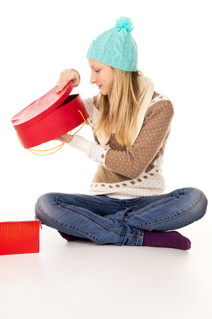 beautiful girl looks in a gift isolatedの写真素材