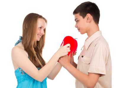 Young boy gives a girl a toyの写真素材