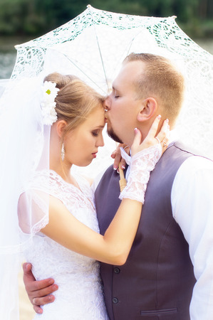 Wedding, the groom kisses the bride on the foreheadの写真素材