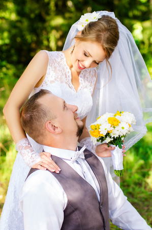 Happy bride and groom looking into each others eyesの写真素材