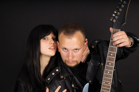Soloist and guitarist with his guitar on a black backgroundの写真素材