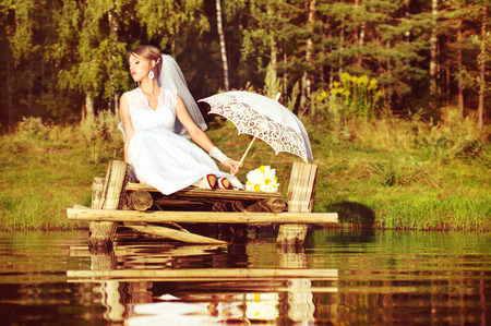 Bride on a bridge near the water in the forestの写真素材