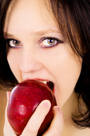 face close-up girl with red appleの写真素材