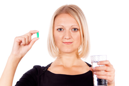 beautiful girl holds pill, isolated on white backgroundの写真素材