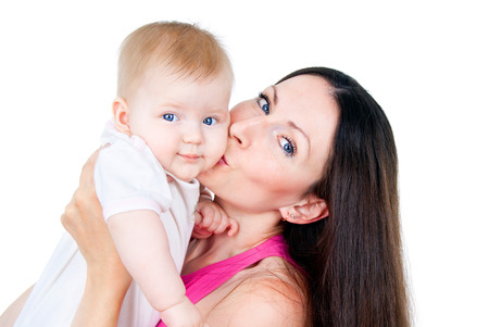 young mother kissing a child isolated on white backgroundの写真素材