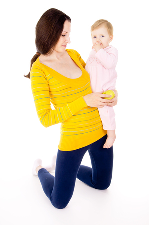 mom and little boy lead the healthy way of life, and eat apples isolated on white backgroundの写真素材
