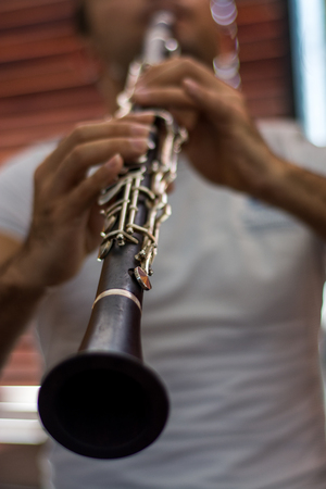 Male musician playing clarine