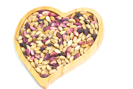 heart plate and pistachiosの写真素材
