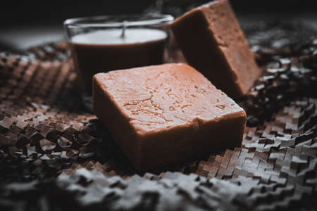 Candles burning in the dark against decorated on wood and Natural made soapの写真素材