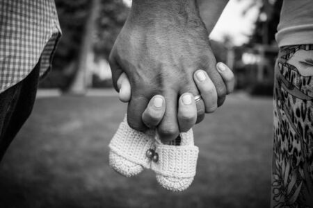 Mother and father holding hands pregnancy announcementの写真素材