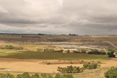 Panorama of open cut surrounded with farms and green fields