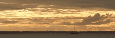 Lord Nelson tall ship moored at Mornington Peninsula coastline in Victoria, Australia with smaller...