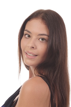 Attractive brunet smiling and looking over shoulder with long hair isolated on whiteの写真素材