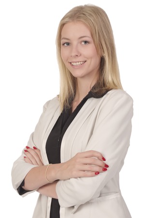 Beautiful blond smiling woman in white business suit posing with her hands crossed in front isolated on whiteの写真素材