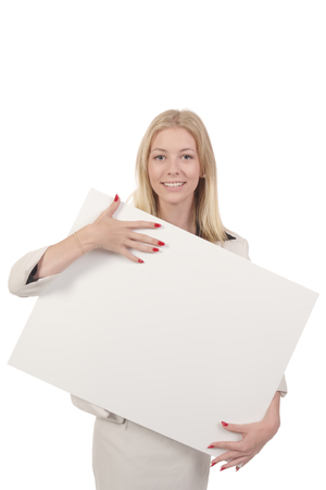 Blond smiling woman in white business suit hugging white board in her hands isolated on whiteの写真素材