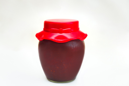 Glass jar with jam on white backgroundの写真素材