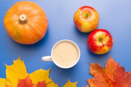 Coffee, leaves and pumpkin on a blue backgroundの写真素材