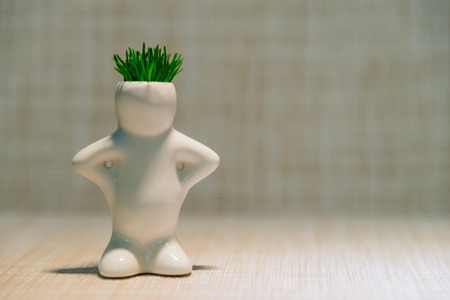 White man with grass on his head on a gray backgroundの写真素材