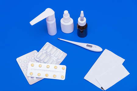 Drops, pills, lekartva and thermometer on a bright backgroundの写真素材