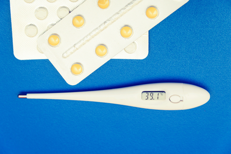 Drops, pills, lekartva and thermometer on a bright backgroundの写真素材