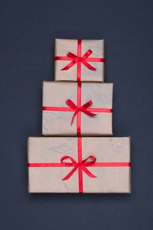 Gift box with a red ribbon lying on a background
