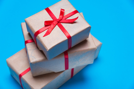Gift box with a red ribbon lying on a background