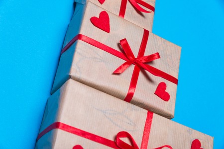 Gift box with a red ribbon lying on a background