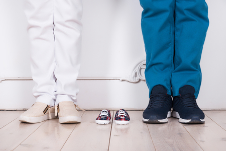 Feet of a married couple in anticipation of a baby on the backgroundの写真素材