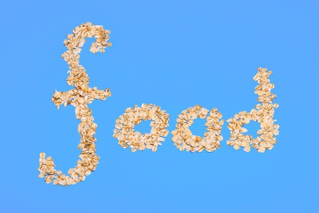 Inscription useful food, oatmeal porridge on a blue backgroundの写真素材