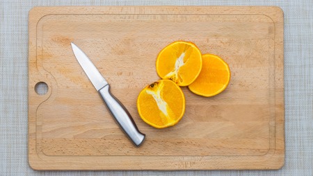 Cutted orange on a wooden boardの写真素材