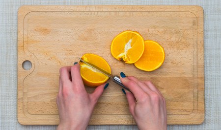 Cutted orange on a wooden boardの写真素材