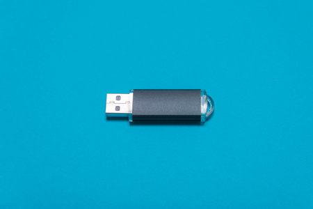 A dark flash drive, a storage medium lying on the background