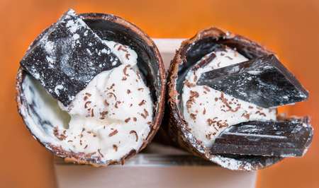 Ice cream in a horn with chocolate and crumbsの写真素材