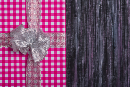 Gift wrapping. A gift for my wife and loved one. A gift for the New year and Christmas. Wooden background.の写真素材