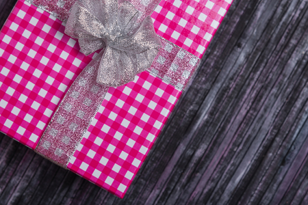 Gift wrapping. A gift for my wife and loved one. A gift for the New year and Christmas. Wooden background.の写真素材