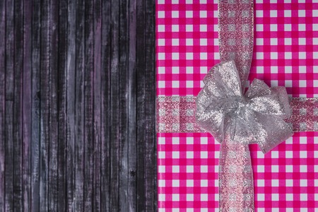 Gift wrapping. A gift for my wife and loved one. A gift for the New year and Christmas. Wooden background.の写真素材
