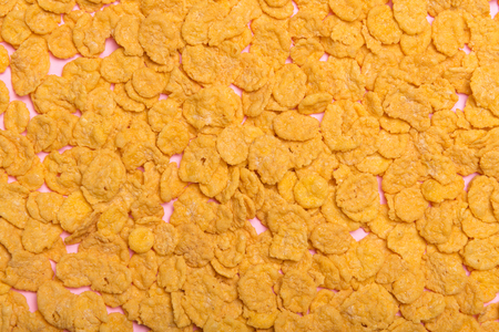 Flakes scattered on the background. Cornflakes. Background for text. Background for the inscription....