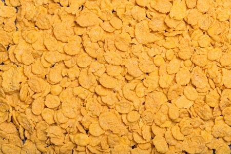 Flakes scattered on the background. Cornflakes. Background for text. Background for the inscription. View from above. Pink background. Pink Lavender.の写真素材