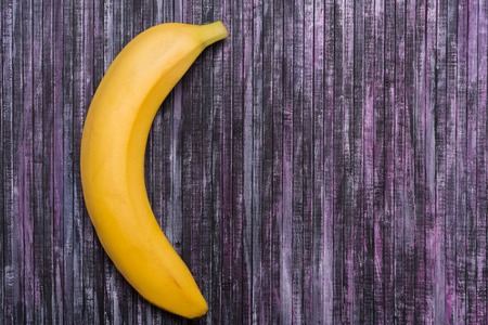 Banana on a wooden background. Useful fruit. Summer. Vacation. Fruit on the background. Place for text. Mock up.の写真素材