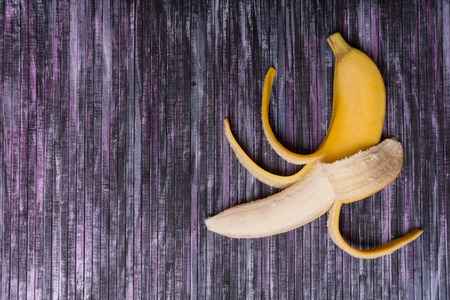 Banana on a wooden background. Useful fruit. Summer. Vacation. Fruit on the background. Place for text. Mock up.の写真素材