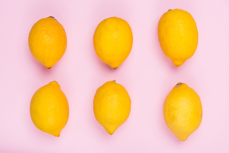 Lemons on a pink background. Citrus fruits. Fruit on the background of the color of Lavender Lavender. Place for the background and the inscription.の写真素材