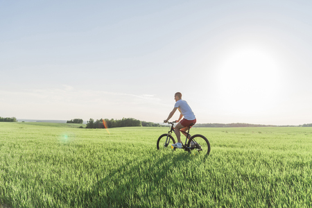 The man is riding a bicycleの写真素材