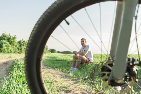 The man sitting on the grassの写真素材