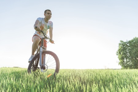 The man is riding a bicycleの写真素材