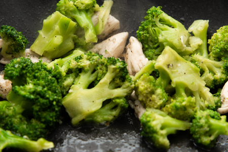 Broccoli fry in a pan with slices of meat. Chicken meat with broccoli. Useful breakfast.の写真素材