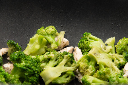 Broccoli fry in a pan with slices of meat. Chicken meat with broccoli. Useful breakfast.の写真素材
